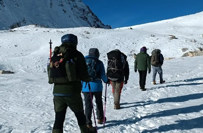 Trekkers crossing a snow-covered pass in the Manaslu region
